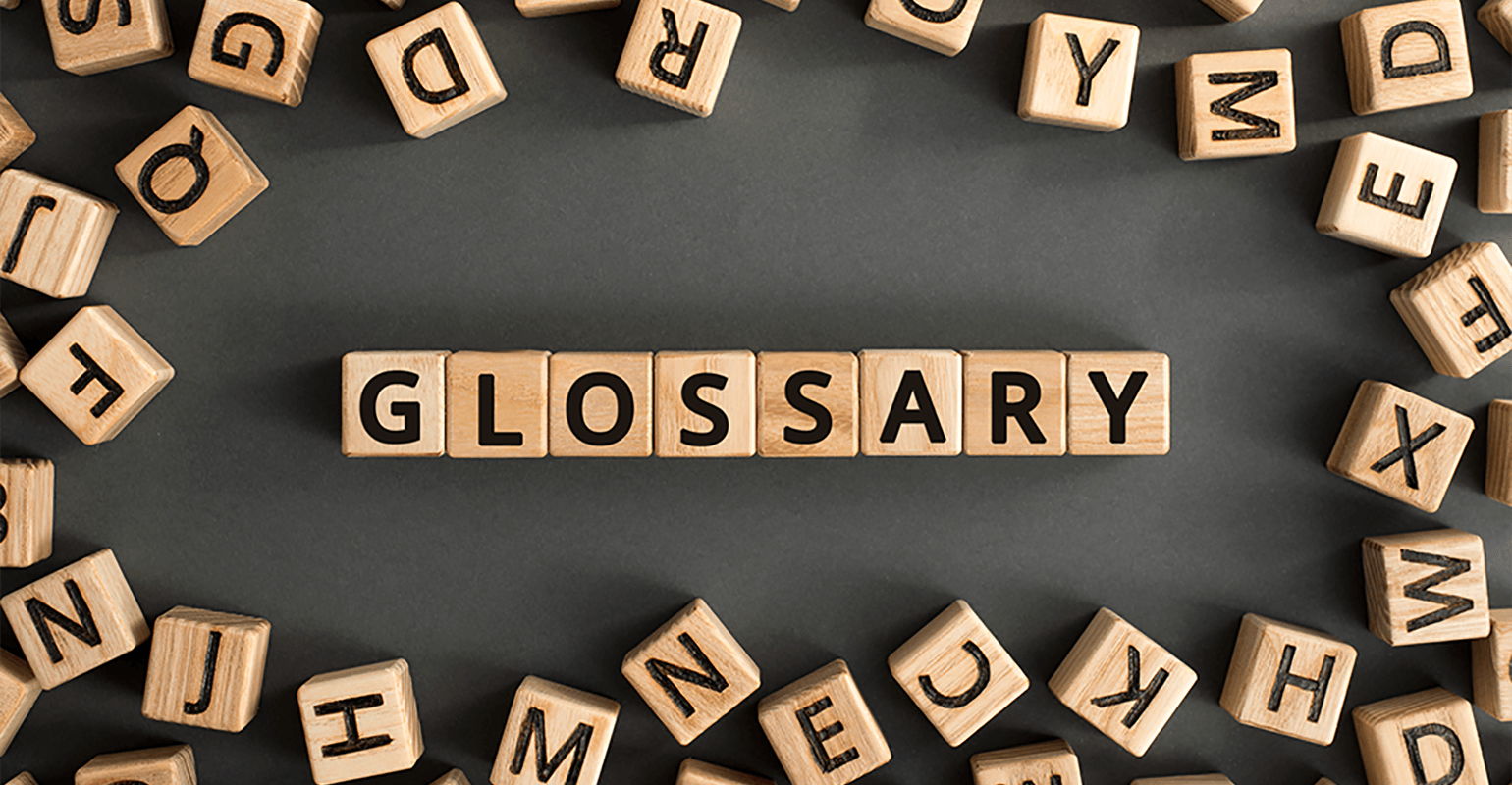 An image of random scrabble letters. In the center the scrabble letters spell out 'glossary'